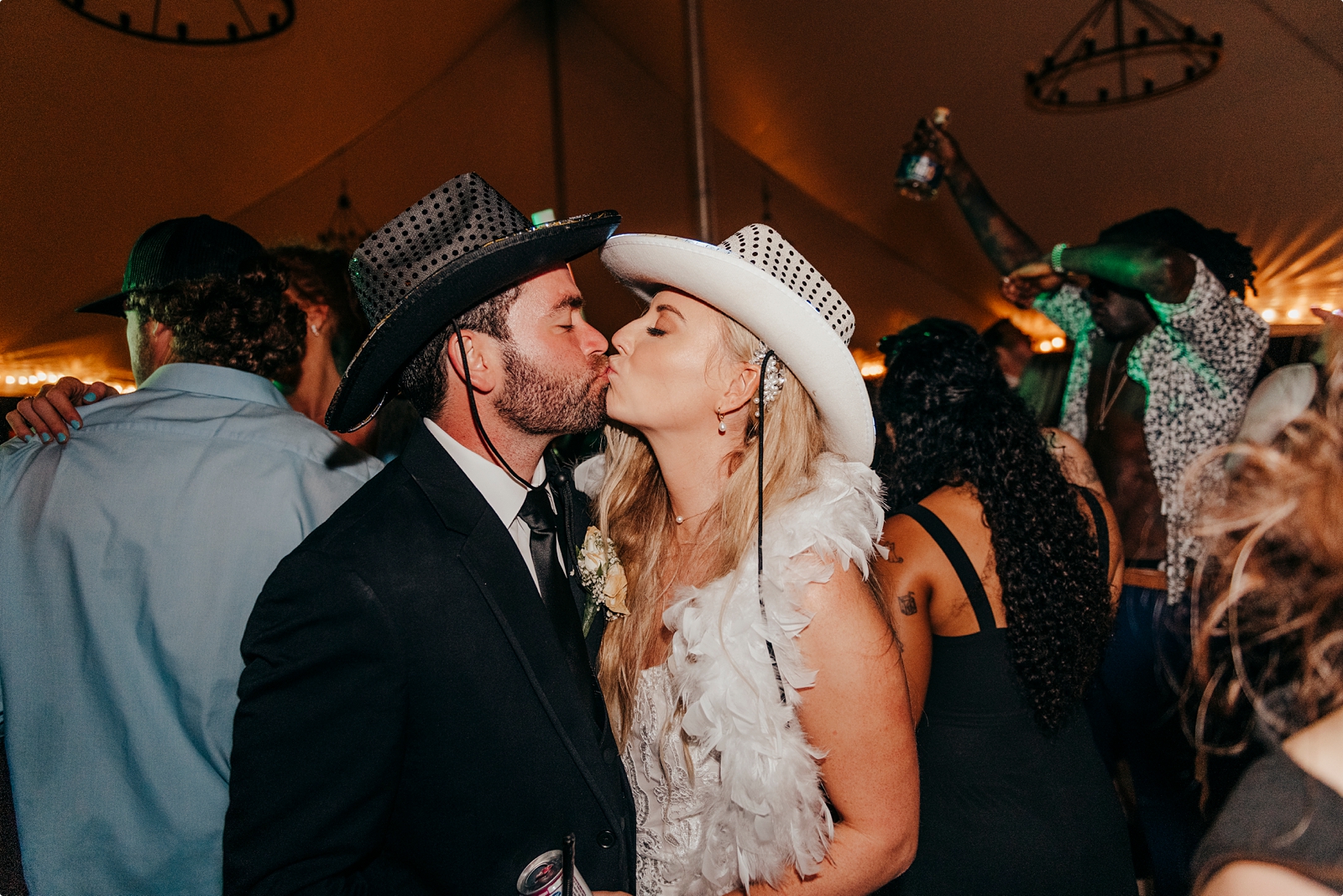 bride and groom at Agapae Oaks Wedding reception wearing cowboy hats