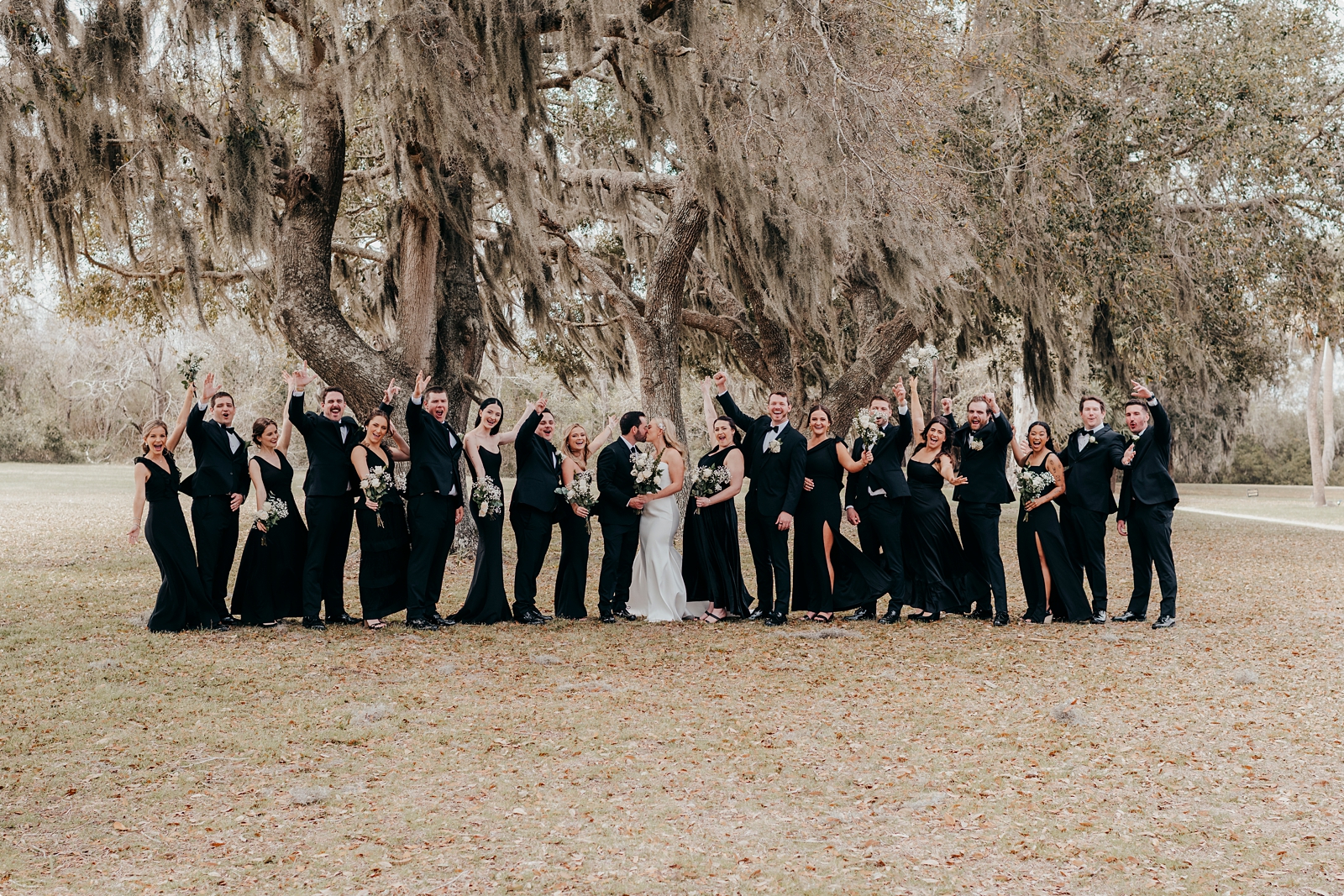Agapae Oaks Wedding photo with wedding party celebrating