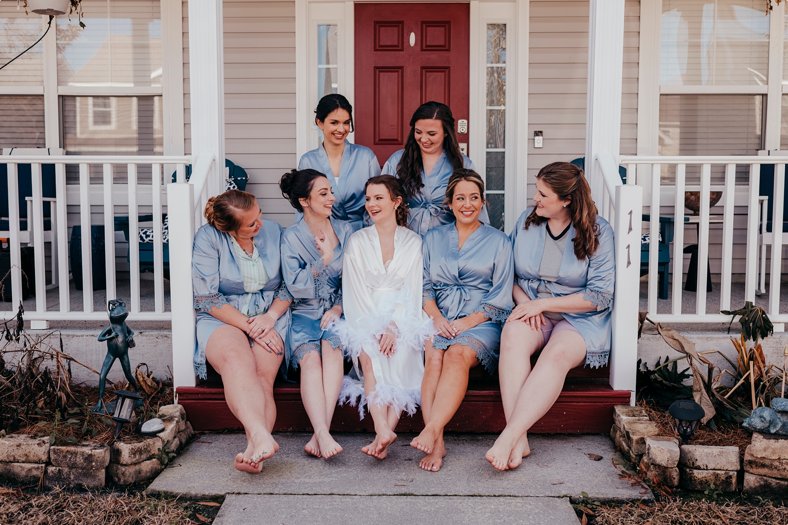 bride and bridesmaids in matching silk robes on wedding day