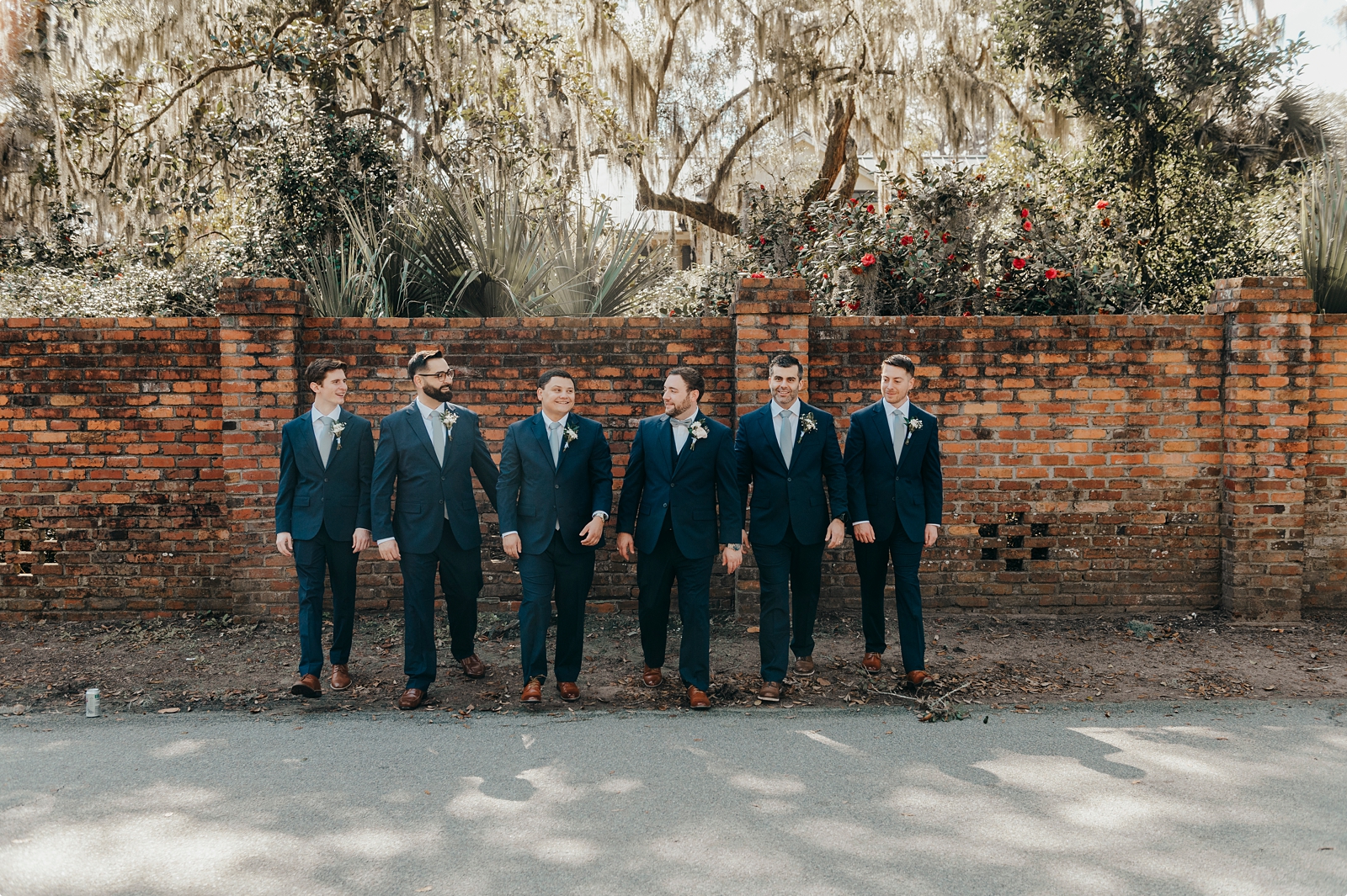groom and groomsmen walking photo