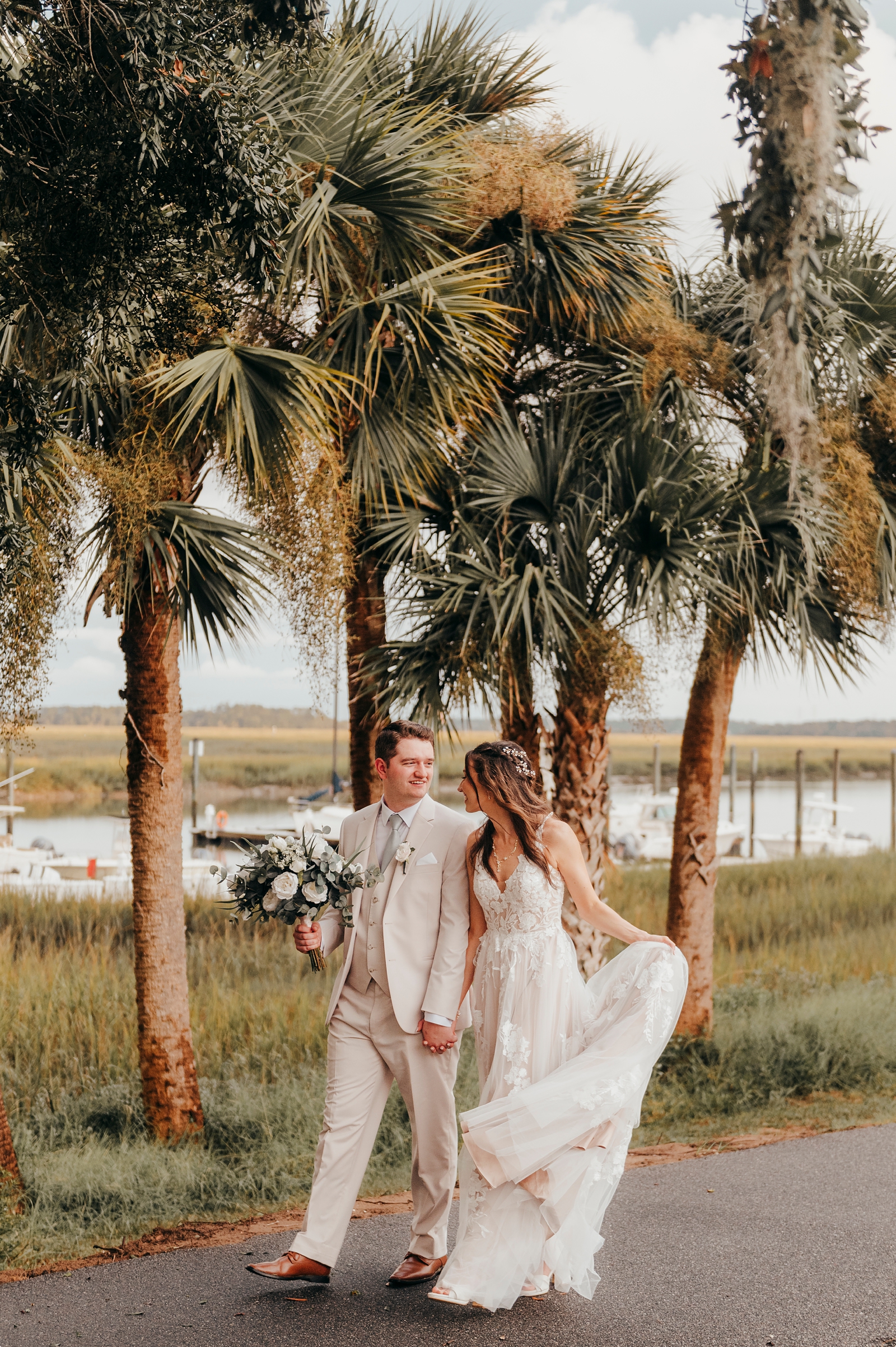 bride and groom walking hand in hand at Moss Creek Country Club Wedding